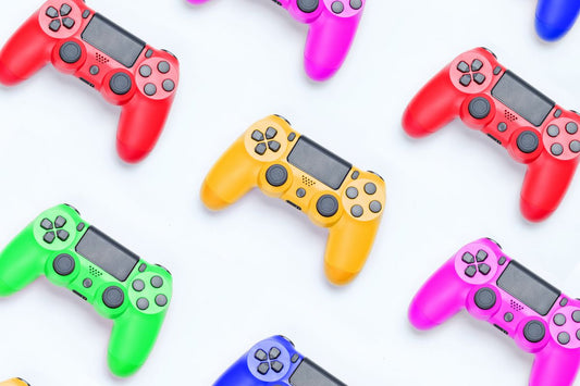 A custom video game controller featuring a colorful paint splatter or graffiti-style design with splashes of blue, pink, and yellow