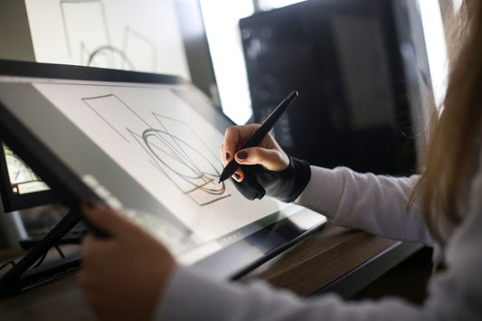a graphic designer drawing on a tablet