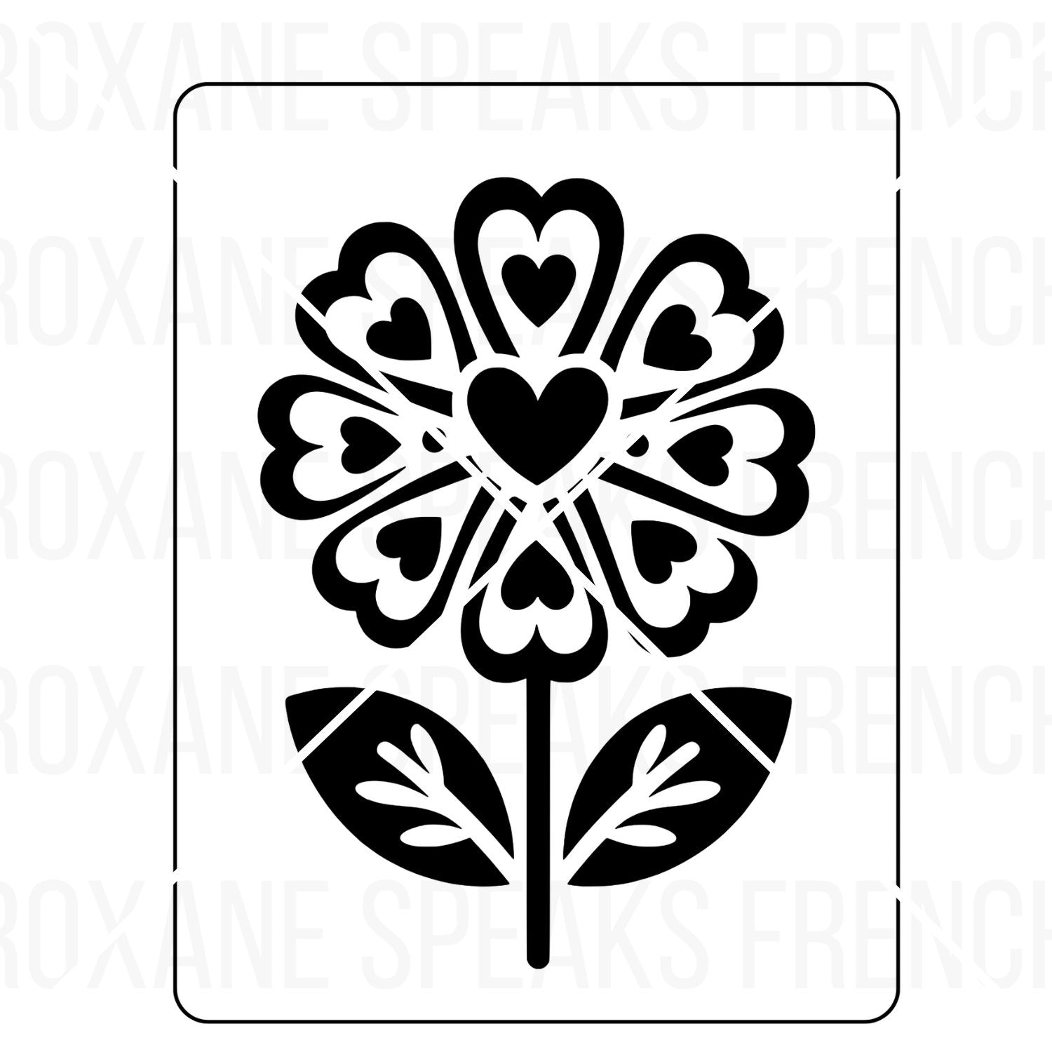 A single flower design with petals shaped like hearts and intricate details, prominently featuring a large heart at the center. The flower has two stylized leaves and is framed within a rounded rectangular border. The entire image is in bold black outlines on a white background, suitable for coloring