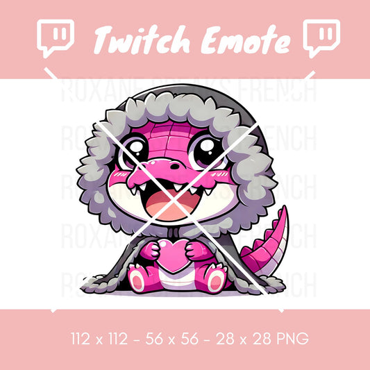 Adorable pink crocodile emote, snug in a fluffy blanket and holding a heart, designed for streamer engagement on platforms like Twitch. Displayed in various resolutions (112x112, 56x56, 28x28 pixels) on a clear background, ideal for digital overlays and chat reactions